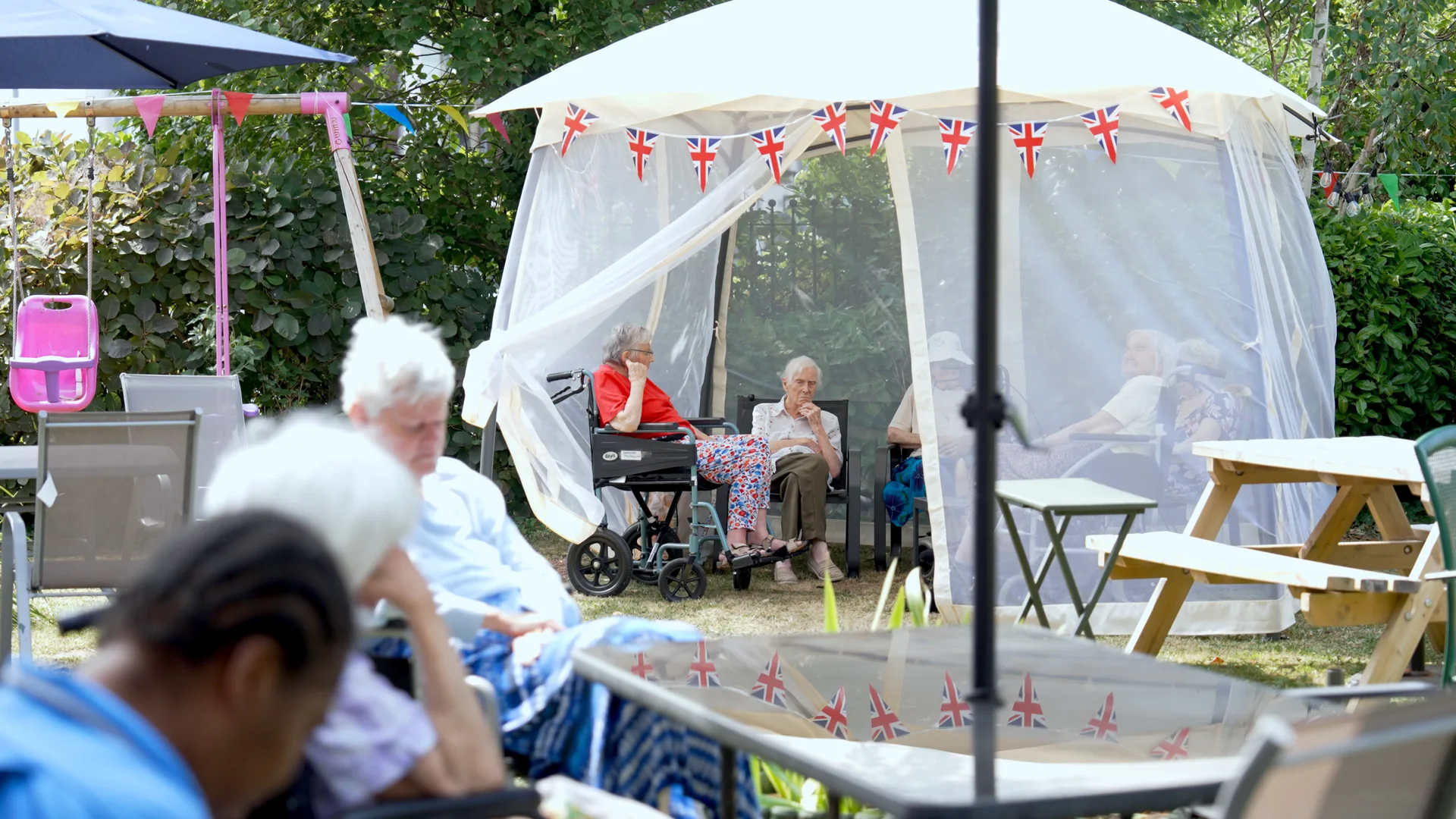Residents together at a summer garden party.