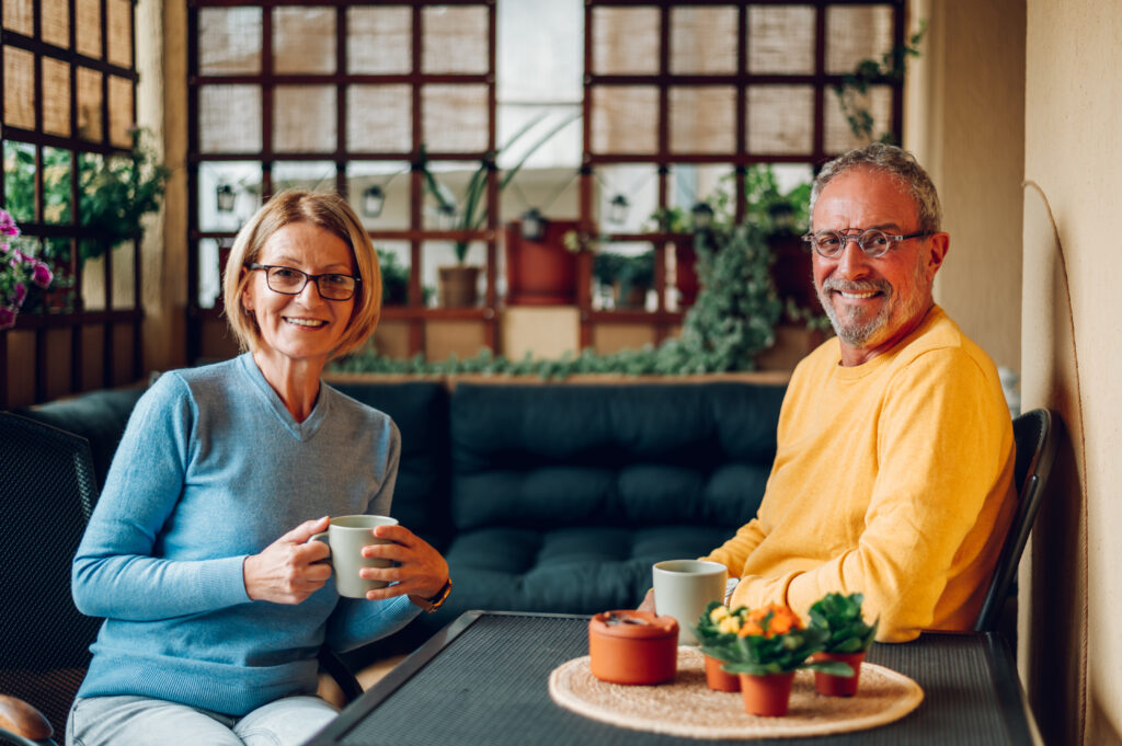 A husband and wife enjoying a coffee together.